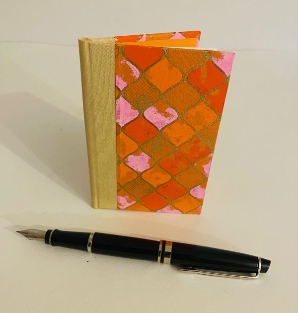 orange and pink small notebook