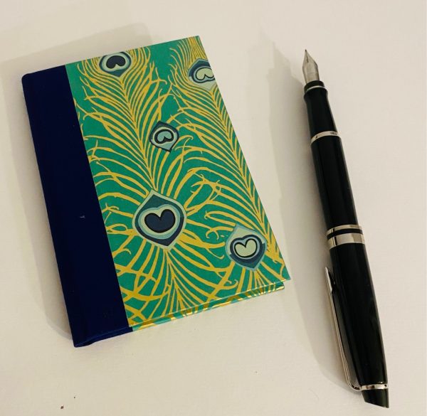 small notebook peacock feathers